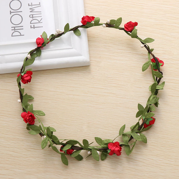 A wreath of red roses and green leaves used as a bohemian flower headband for women.