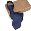 Navy blue striped tie displayed on a brown gift box.