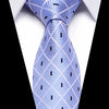 A close-up shot of a light blue silk jacquard tie worn against a white shirt.