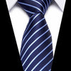 A dark blue striped silk tie tied in a knot against a white shirt background.