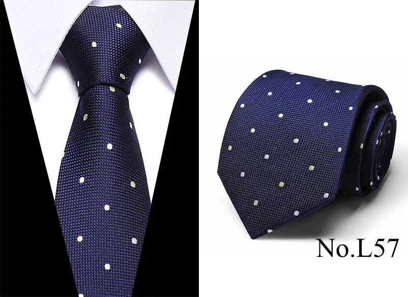 Navy blue silk jacquard tie with small gold dots shown against a white shirt.