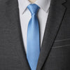 A light blue striped tie worn under a gray suit jacket and white shirt.
