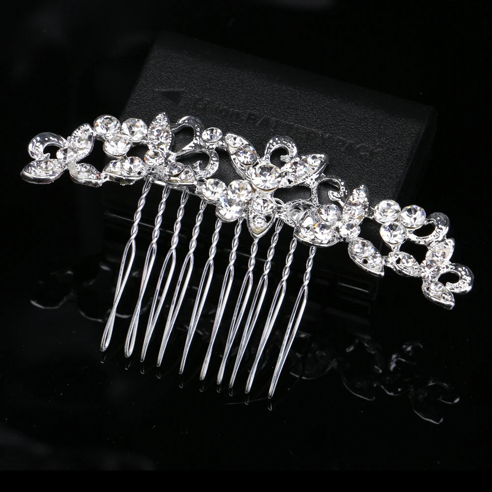 A silver rhinestone bridal hair comb tiara with delicate dangling strands shown against a black background.