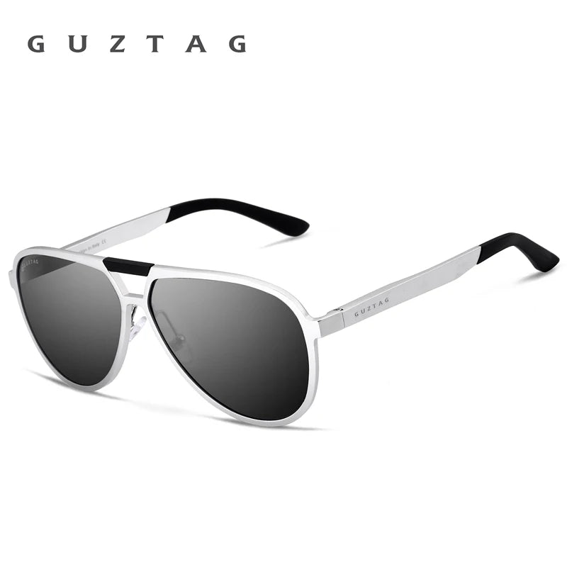 Silberne Aluminium-Sonnenbrille mit schwarzen Rahmen und dunklen Linsen vor weißem Hintergrund.