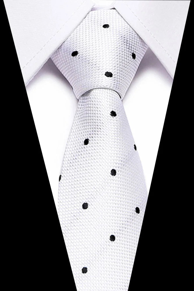 A white silk jacquard tie with black polka dots tied in a formal knot.