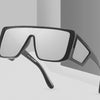 A pair of oversized gradient square sunglasses with black frames shown in a studio setting.