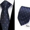 Navy blue silk jacquard tie with a subtle geometric pattern shown on a white shirt.