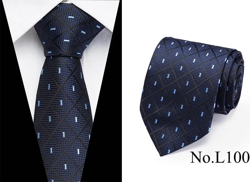 Navy blue silk jacquard tie with a subtle geometric pattern shown on a white shirt.