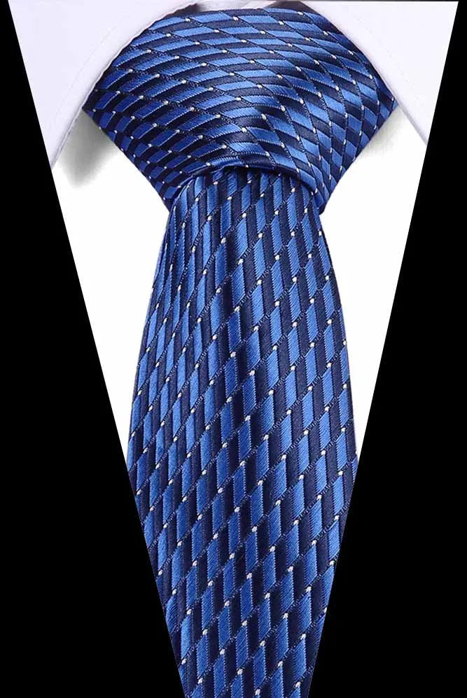 A close-up of a blue silk jacquard tie tied and displayed against a white shirt.