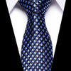 A dark blue silk jacquard tie with a checkered pattern displayed against a white shirt.