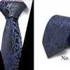 A dark blue silk jacquard tie with intricate blue floral patterns shown against a white background.