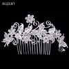 A silver rhinestone bridal hair comb featuring floral designs and delicate curls.