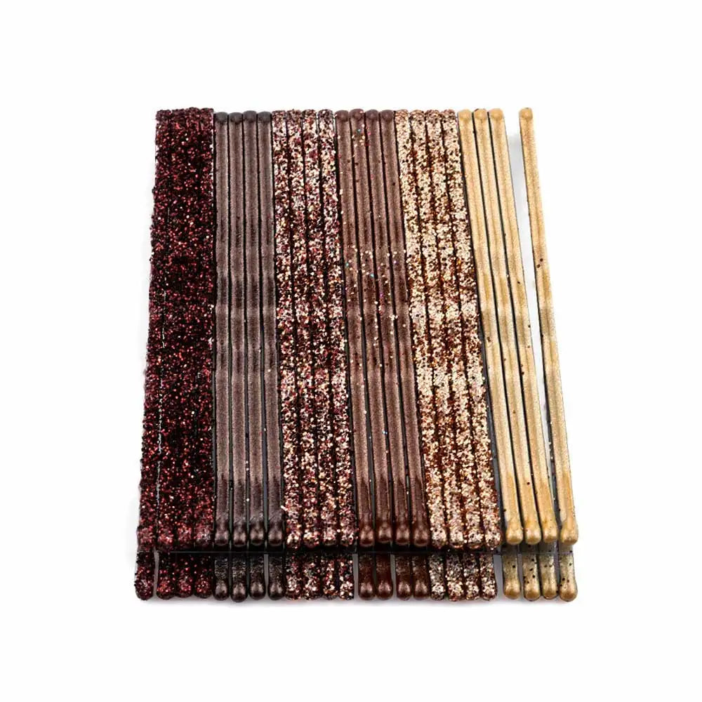 A set of 24 glitter wavy hair clips and bobby pins in various shades of brown and gold.