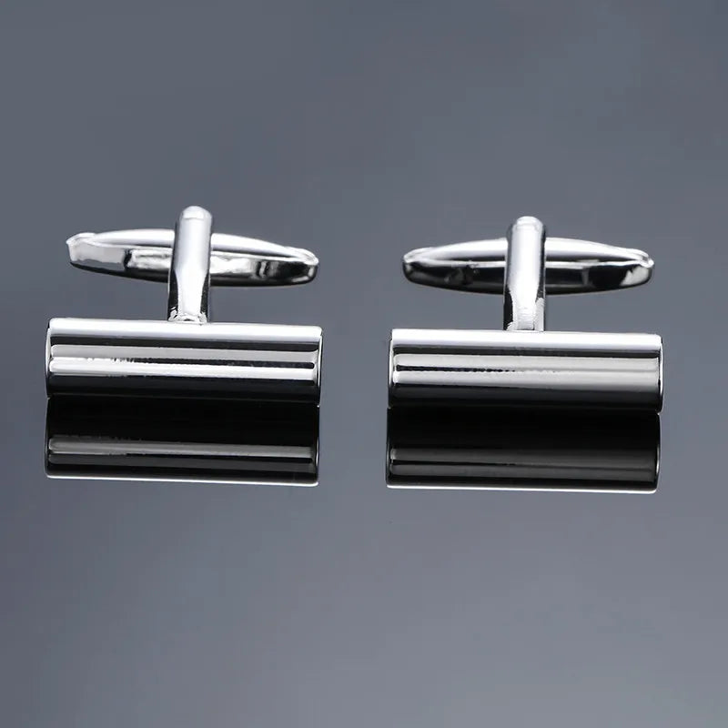 A pair of men's classic copper square cufflinks with silver-toned clasps and polished metal finishes.