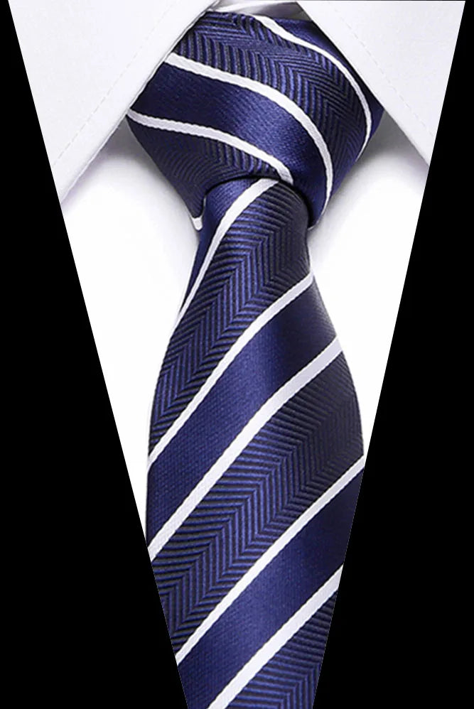 A dark blue silk jacquard tie with white diagonal stripes worn against a white shirt.
