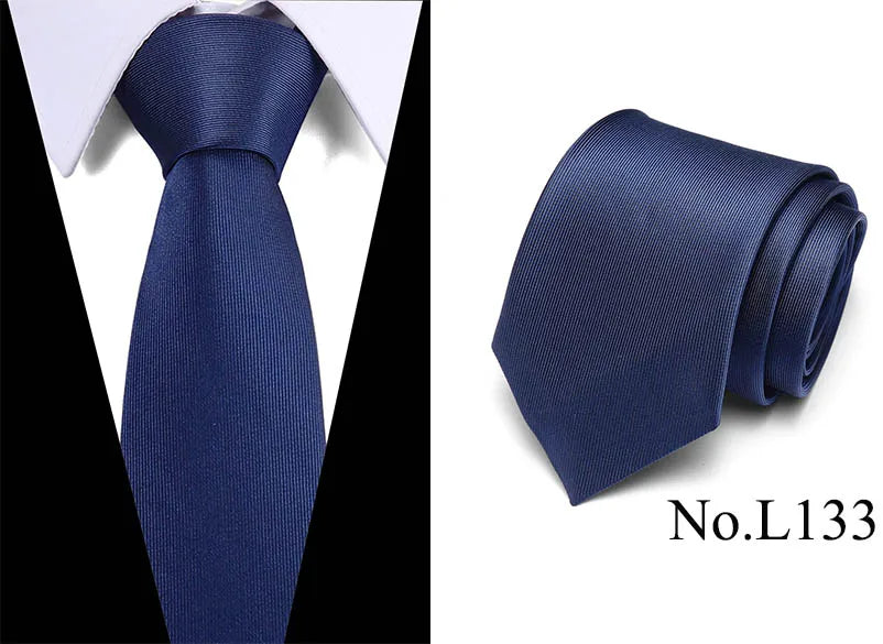 Dark blue silk jacquard necktie folded and displayed against a white background.
