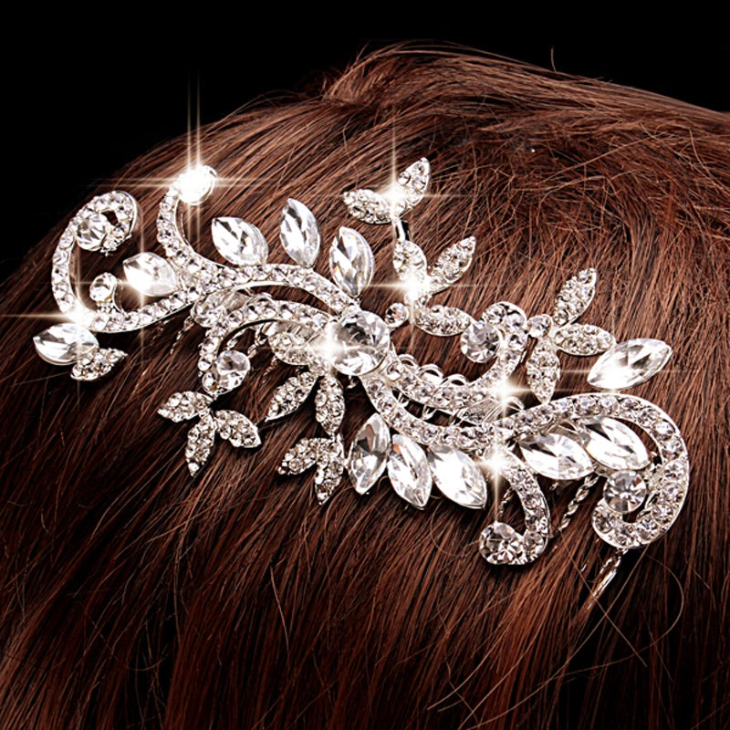 A close-up of a trendy silver rhinestone bridal hair comb tiara adorning dark brown hair.