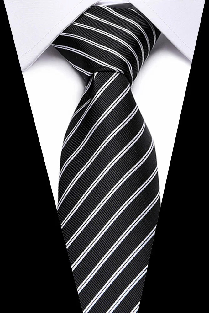 A black and white striped silk jacquard tie tied in a knot against a white shirt background.