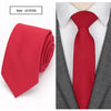 A red slim fit wool neck tie worn under a gray suit jacket and white shirt.