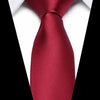 A close-up of a deep red silk jacquard tie with a white collar visible.