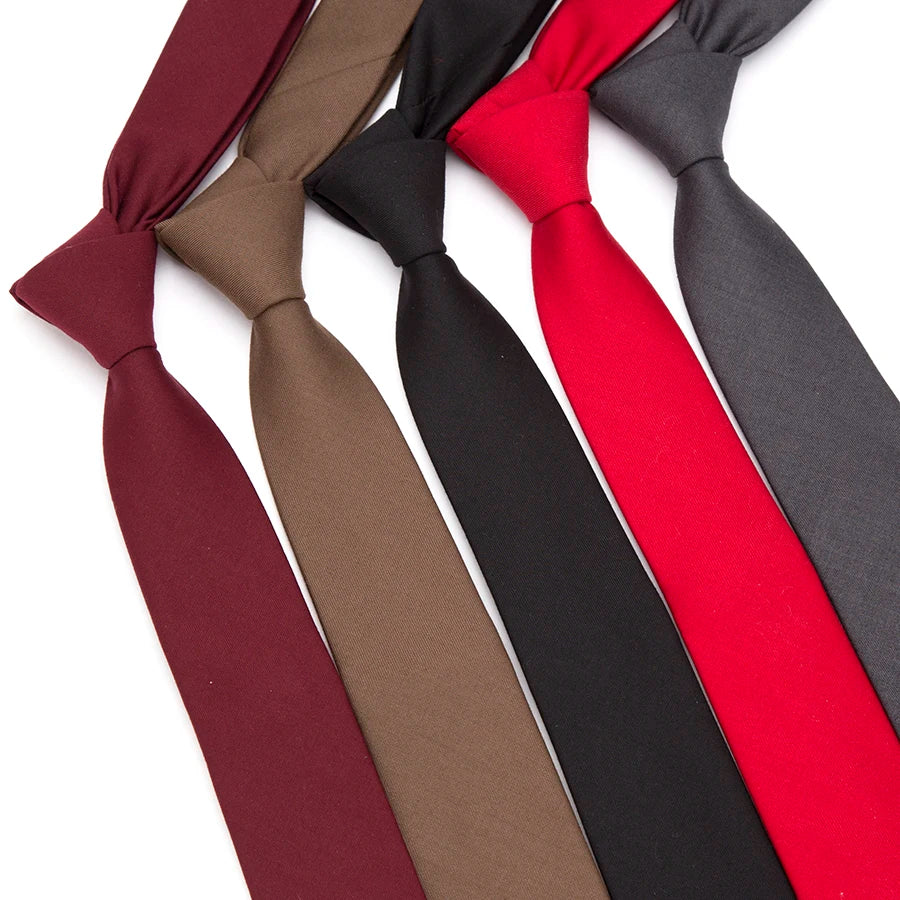 A collection of slim fit wool neckties in various solid colors including burgundy, brown, black, and red.