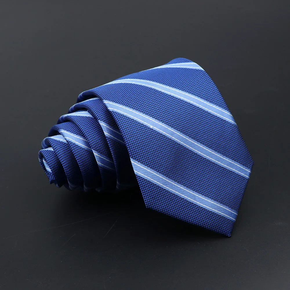 A folded blue and white striped necktie against a dark background.