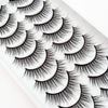 A close-up of dramatic mink false eyelashes displayed on a white surface.