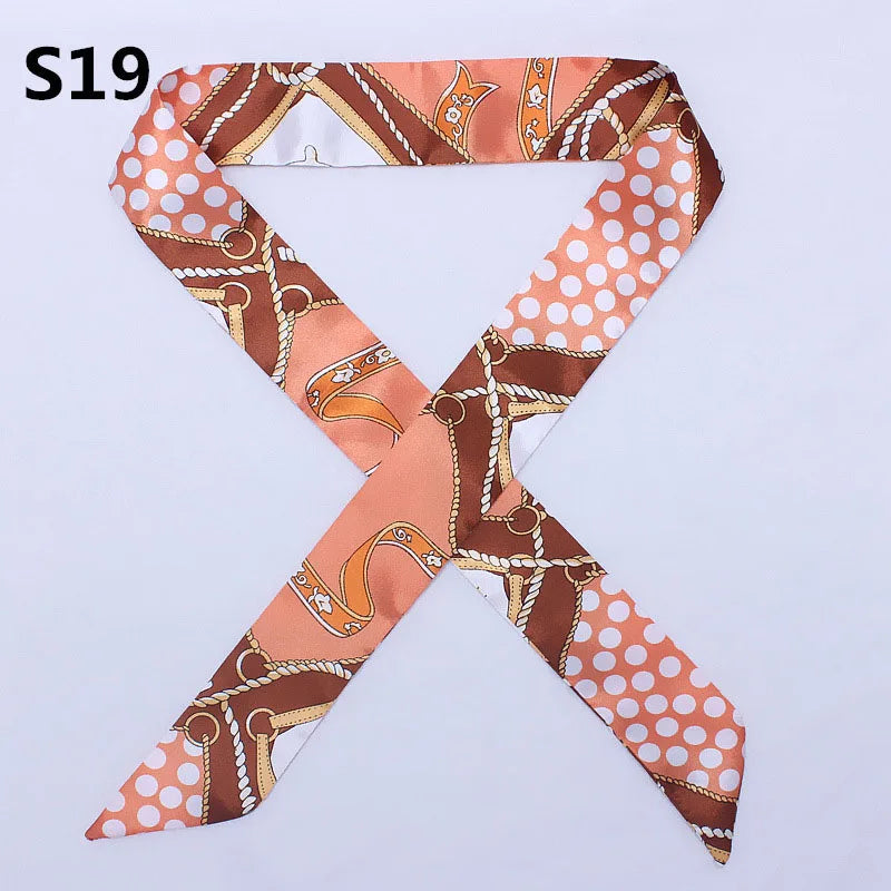 An orange and brown patterned silk headband scarf with a leopard print design