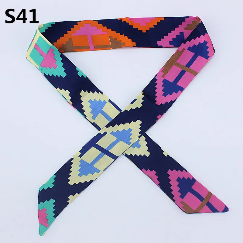 A multi-color silk headband scarf featuring a leopard print pattern in shades of purple, pink, orange, and blue.