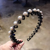 A black elastic hair hoop adorned with clear pearl and rhinestone embellishments.