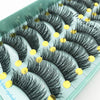 A display of black mink false eyelashes arranged on a light green tray.