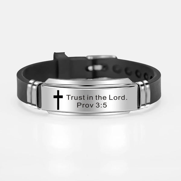 A black leather bracelet with a silver plate engraved with the text Trust in the Lord Proverbs 3:5