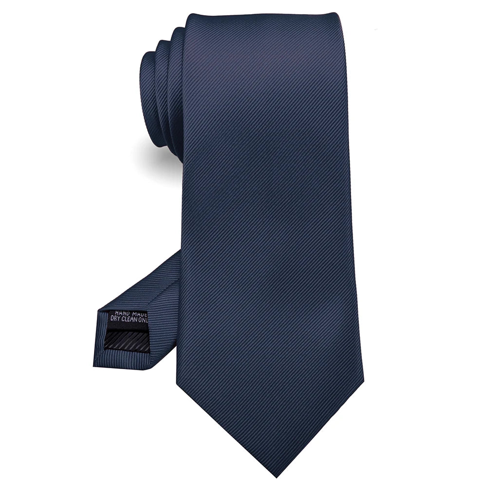 Cravate en soie jacquard bleu foncé pliée et présentée sur fond blanc.