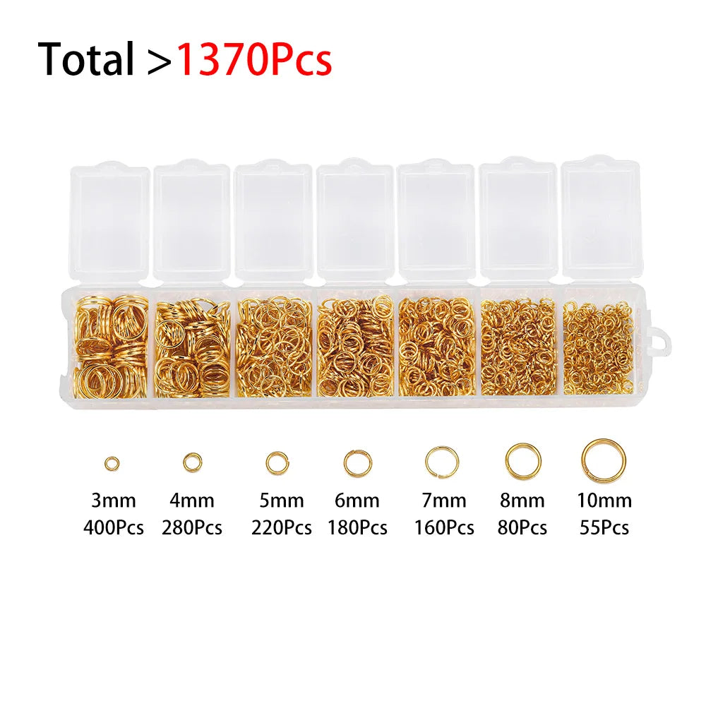 A set of jewelry findings including various sizes of gold-colored jump rings and clasps packaged in clear plastic compartment