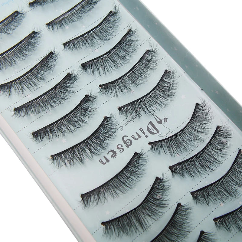 A close-up of a palette showing various styles of black mink false eyelashes.