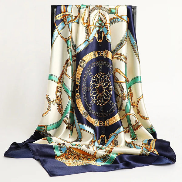 A luxurious satin silk scarf featuring blue, gold, and cream patterns draped elegantly.