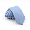 A light blue men's tie folded neatly on a white background.