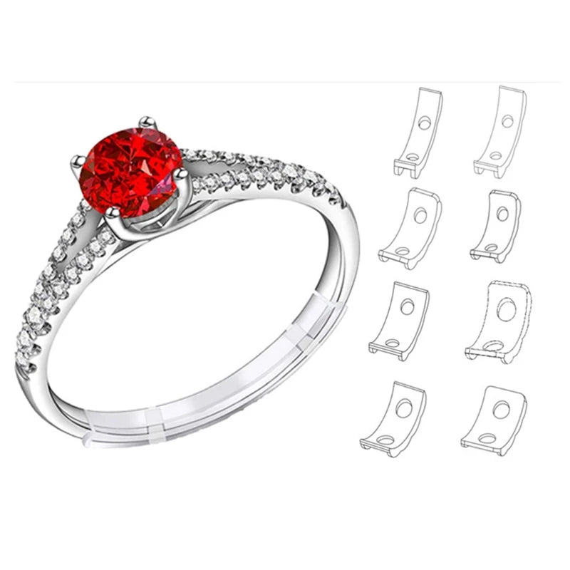 A silver ring with a large red gemstone and a set of silicone ring size adjusters.
