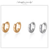 A set of minimalist hoop earrings in both gold and silver finishes.