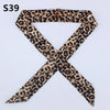 A black and brown leopard print silk headband or scarf tied in an 'X' shape.