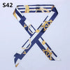 A navy and white striped silk scarf tied in an 'X' shape with gold accents