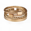 A gold-toned stainless steel bracelet featuring a woven design and Roman numerals.