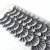 A display of dramatic mink false eyelashes arranged in a fan pattern on a white tray.