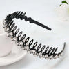 Black rhinestone anti-slip hairband for women displayed on a white surface.