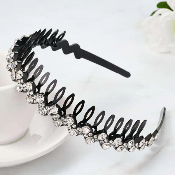 Black rhinestone anti-slip hairband for women displayed on a white surface.