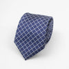 A dark blue patterned necktie with a grid of white dots and stripes folded neatly.