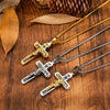 A set of retro Christian cross amulets necklaces in gold and silver tones displayed on a wooden surface.