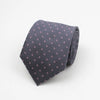 A dark gray necktie with a small pink dot pattern folded neatly.