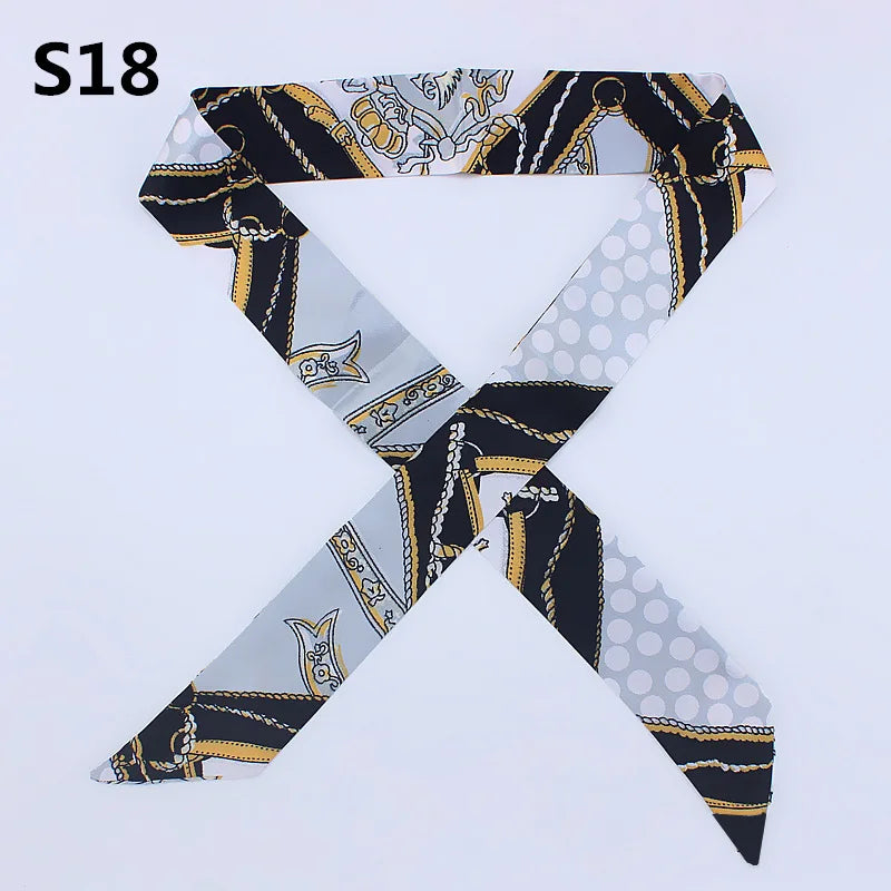 A black and white patterned silk headband or scarf with a leopard print design