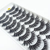 A strip of dramatic mink false eyelashes is shown on a white plastic tray.